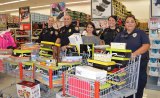 The Lemoore Police Department and local volunteers do a little shopping for shoes, which they will distribute to kids on Monday, Nov. 16 at the Lemoore Police Department.